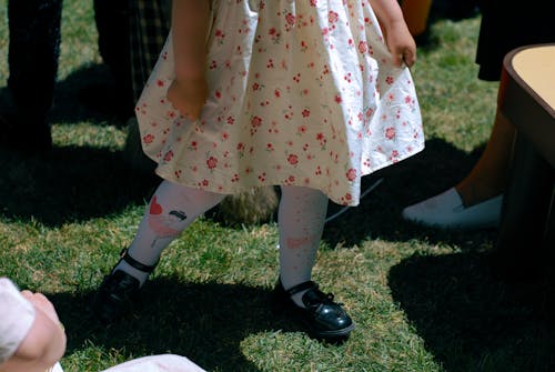 Free A Little Girl Wearing a Dress with a Floral Pattern  Stock Photo