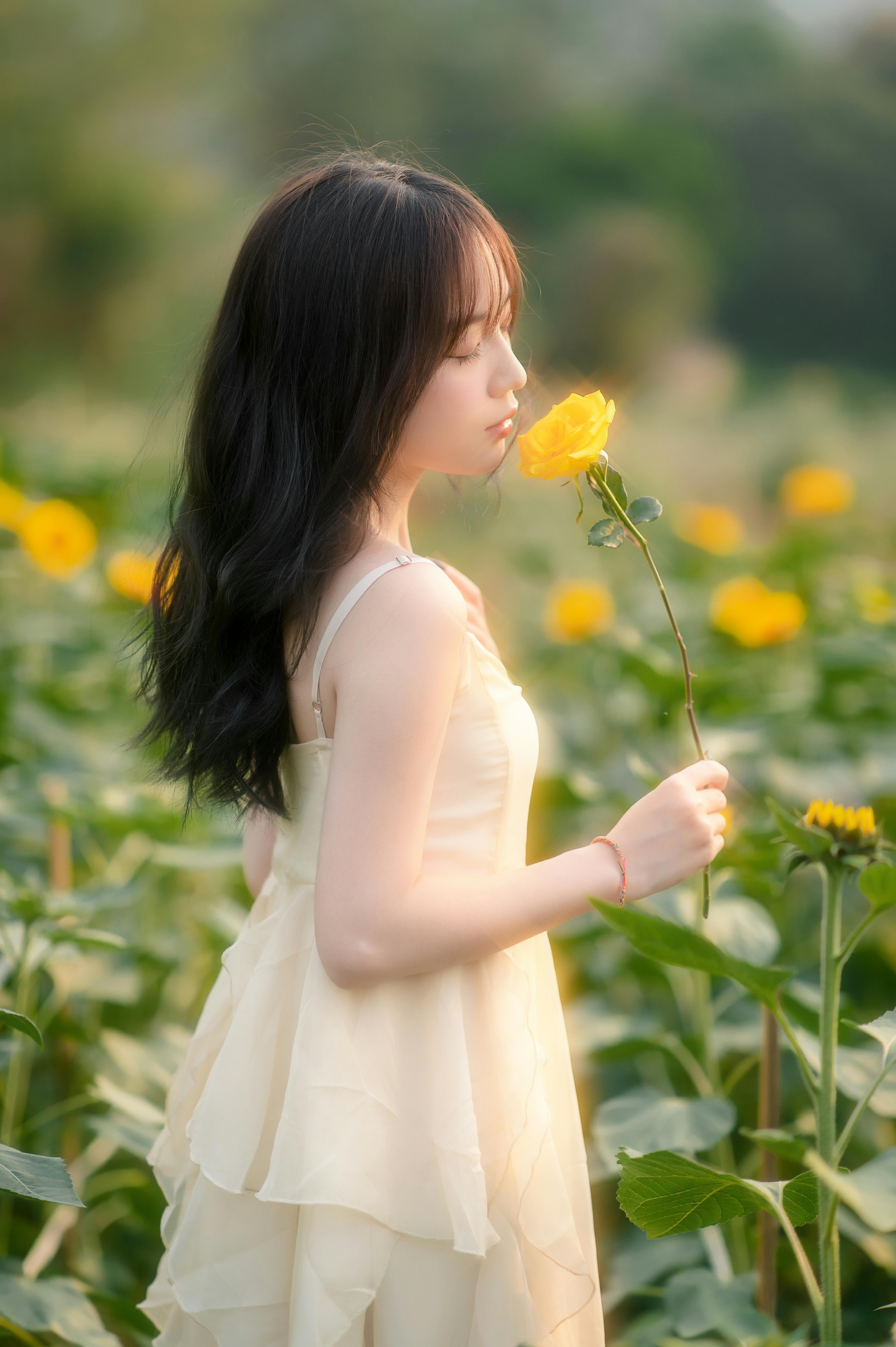 Woman Smelling Yellow Rose · Free Stock Photo