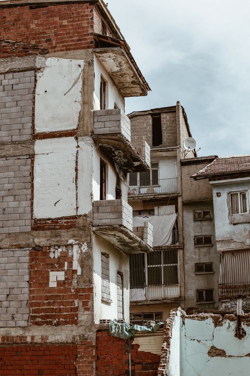 Free Rustic facades of neglected buildings in an urban residential district with a vintage aesthetic. Stock Photo