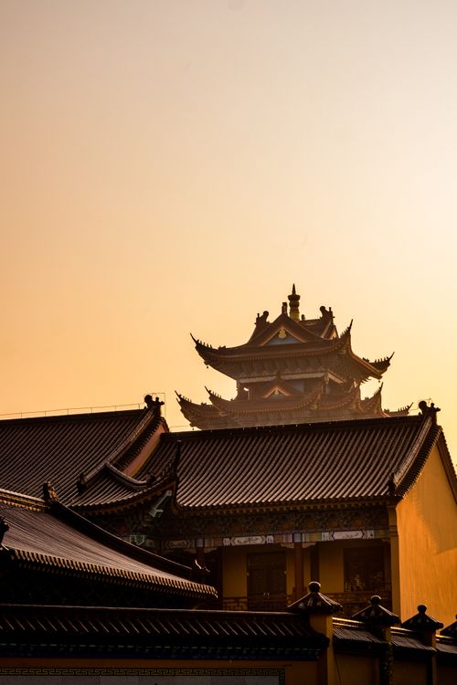 Free Dramatic sunset view over traditional Asian pagoda rooftops, showcasing stunning architecture. Stock Photo