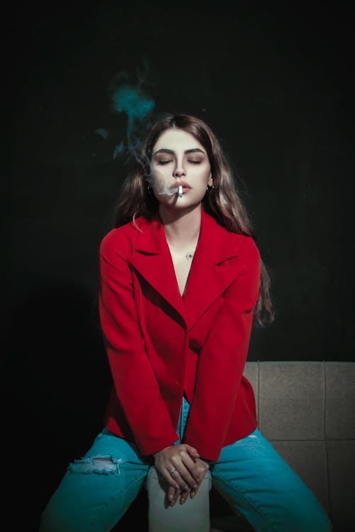 Portrait of Woman in Coat Smoking Cigarette