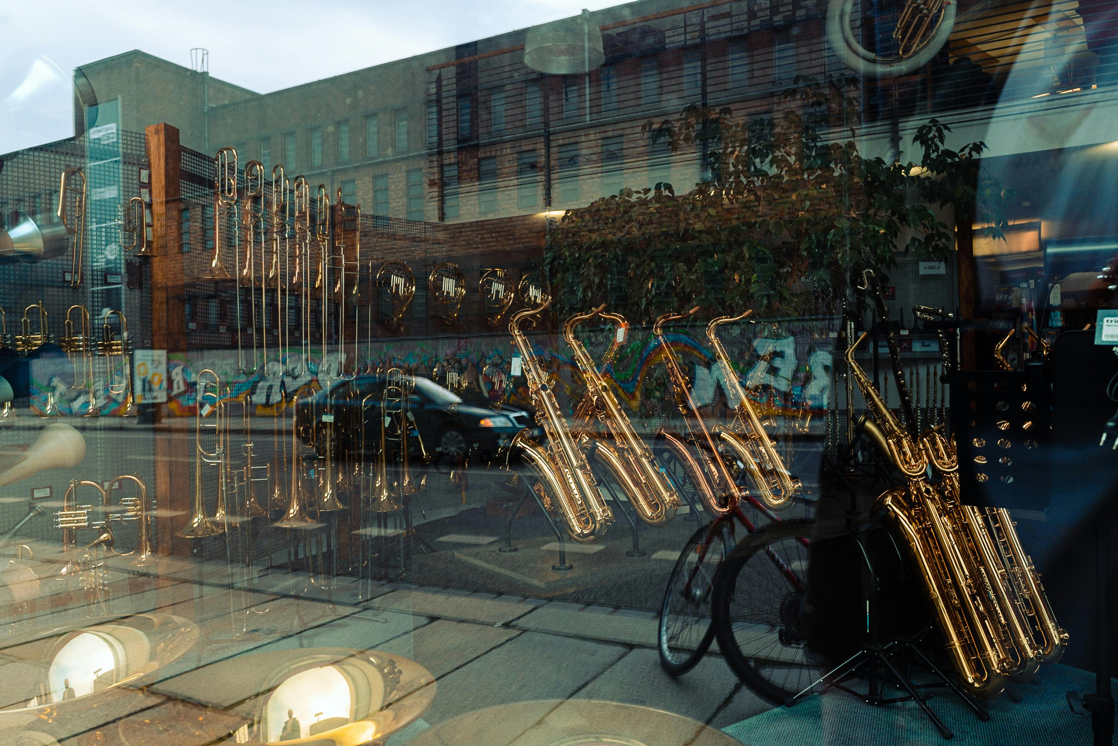 Saxophones Reflection in Window · Free Stock Photo