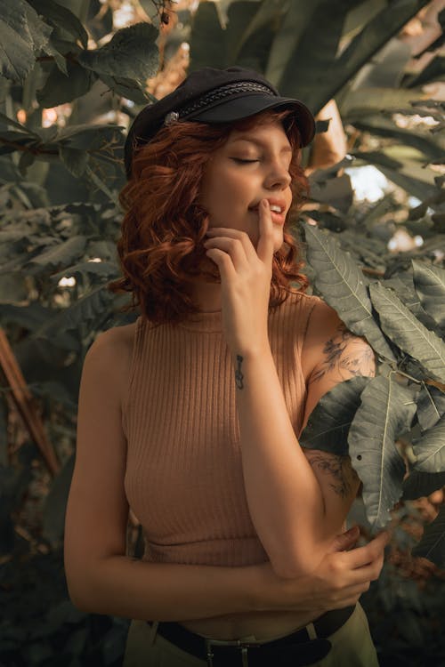 Redhead Woman Posing among Leaves