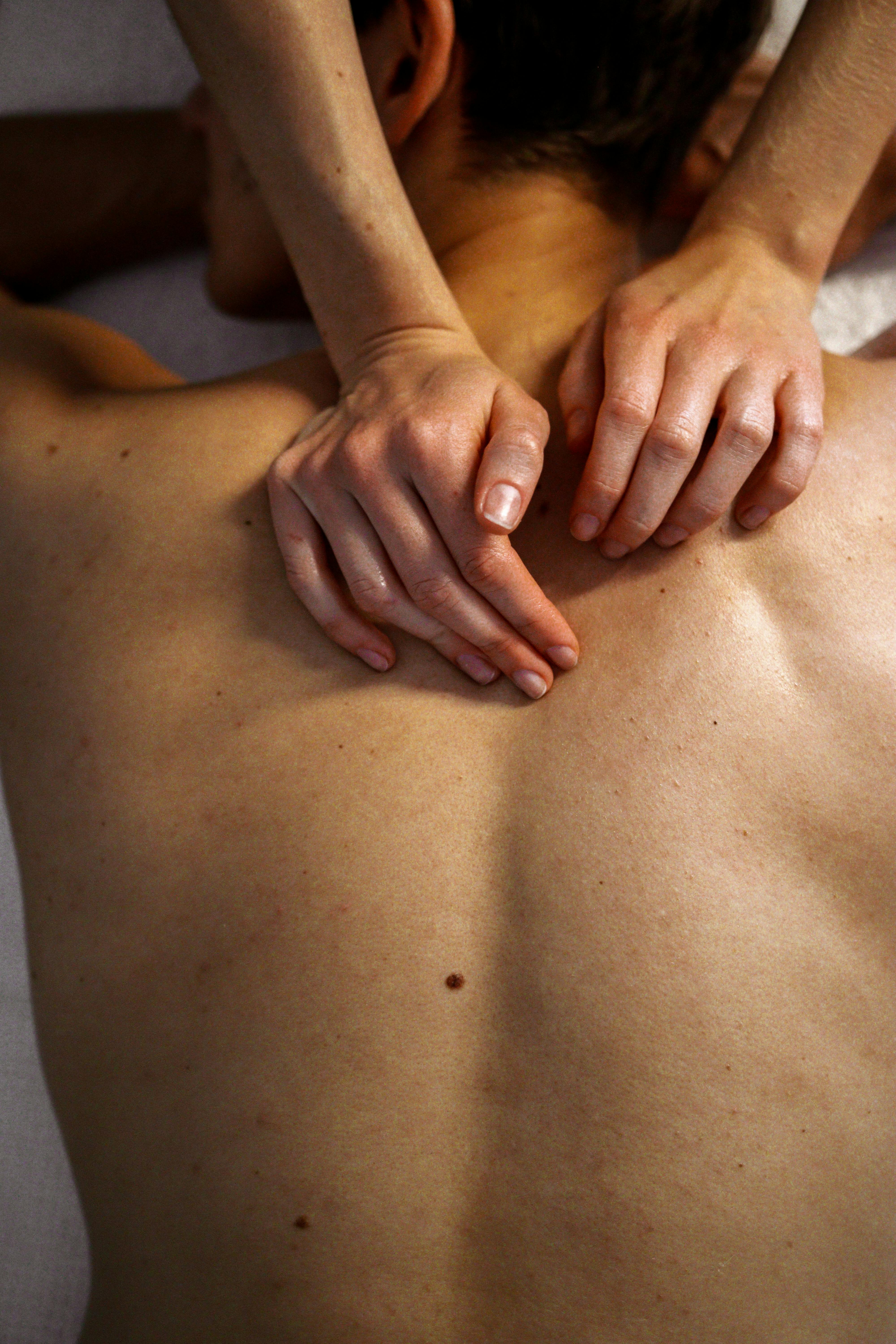 High-angle view of a soothing back massage therapy session highlighting expert hand techniques.