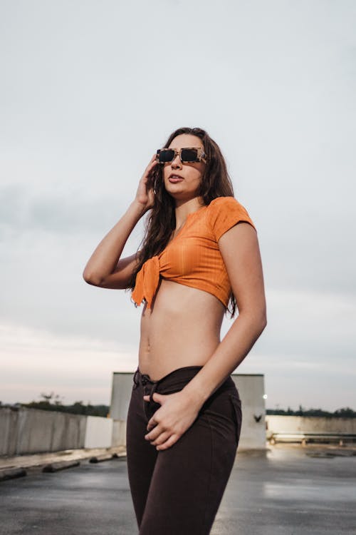 Woman in Sunglasses and Orange Top