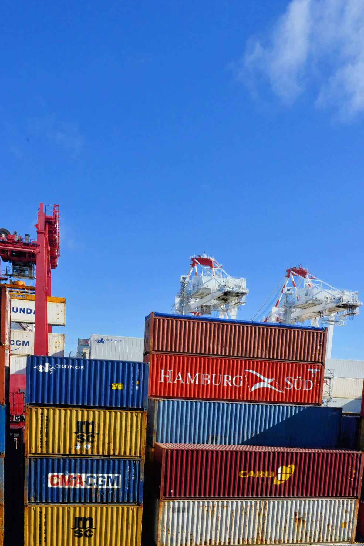 Intermodal cargo containers stacked at a busy shipping port