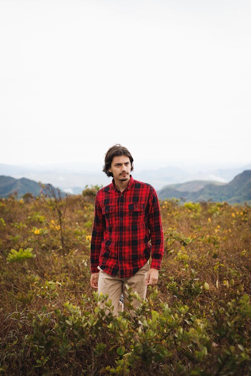 Man in a Flannel Shirt in Mountains