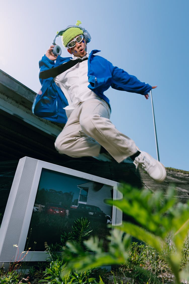 Stylish Man With Headphones Jumping Outdoors