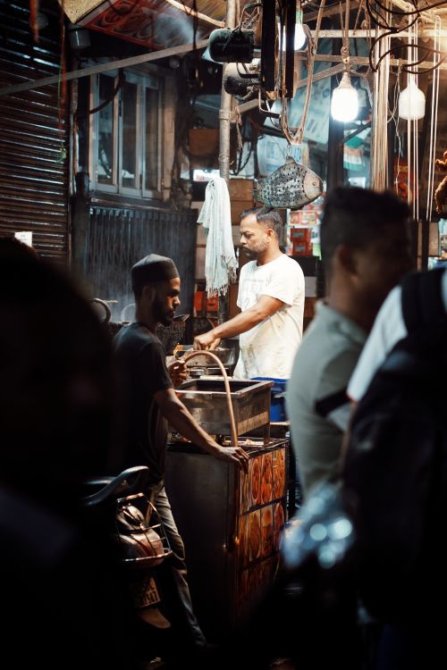 Free Experience the bustling night street food market in Delhi, capturing the lively atmosphere with locals in action. Stock Photo