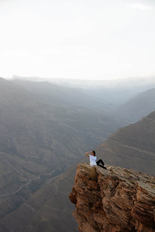 Hiker Sitting on a Rock Overhang