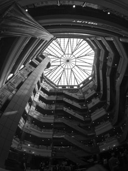 Black and white view of Jamuna Future Park's atrium in Dhaka, showcasing modern architecture.