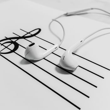 A person using a smartphone to stream popular Hindi tracks on a music app.