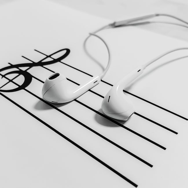 A person using a smartphone to stream popular Hindi tracks on a music app.