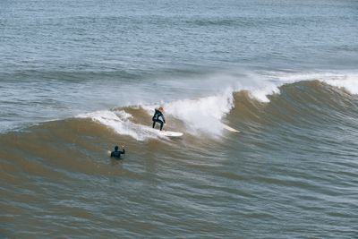 Surfer riding a breaking wave — Josh Hild on Pexels