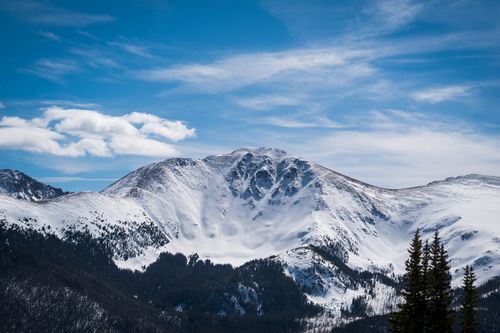 Free Beautiful snowy mountain peaks under a clear blue sky, offering breathtaking winter scenery. Stock Photo