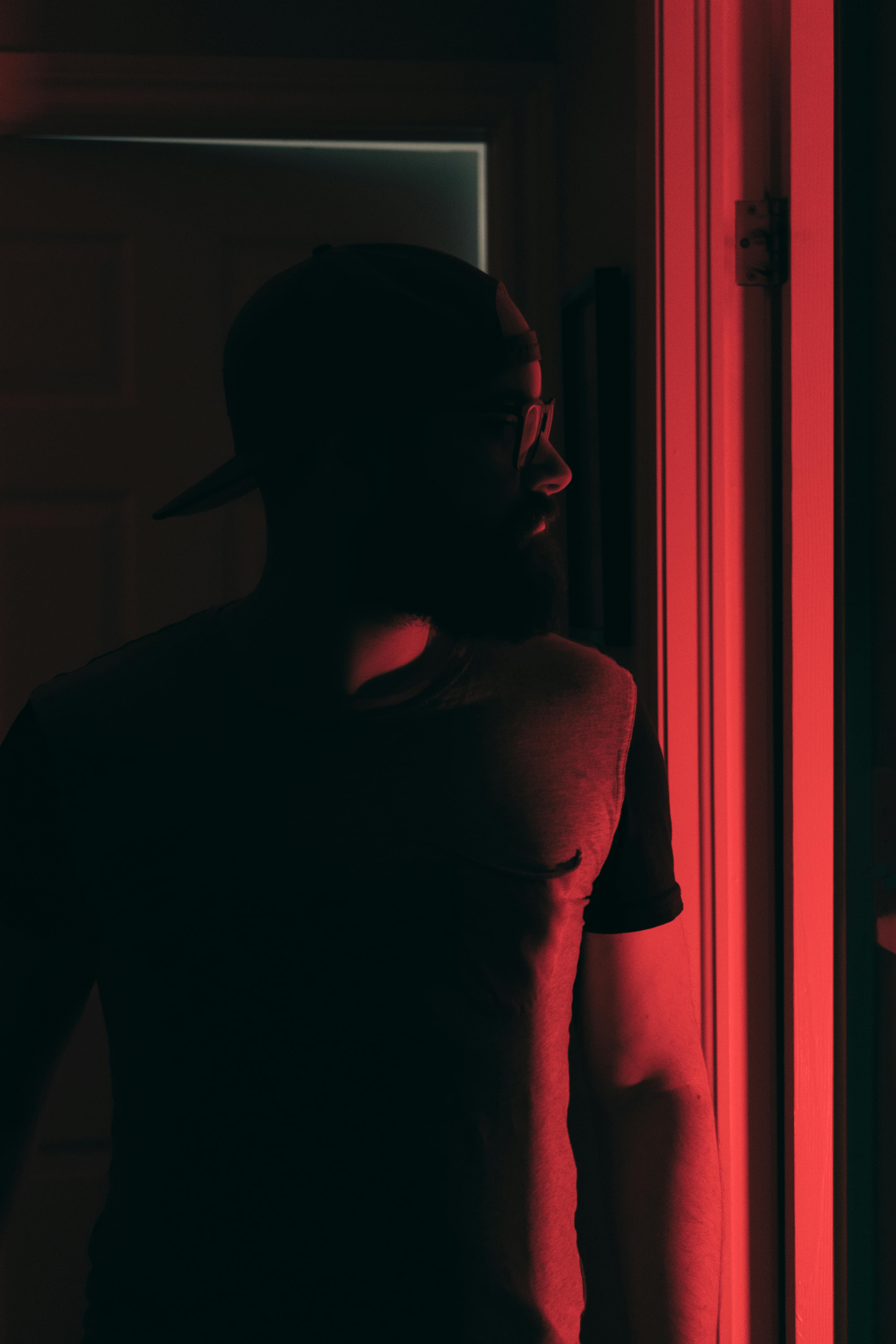 Red Light over Man Standing in Darkness · Free Stock Photo