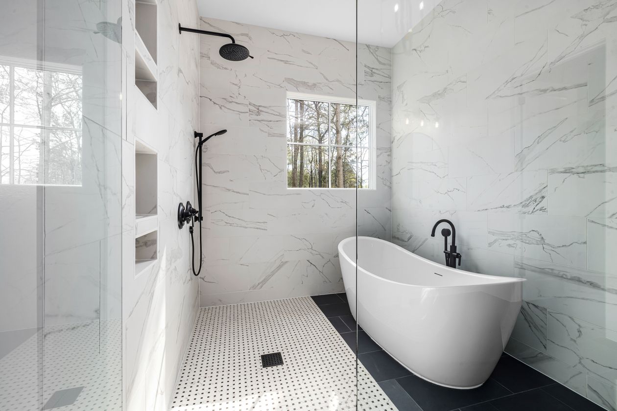 White marble walk-in shower with a tall multi-tier wall niche