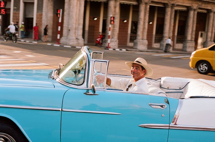 Man In Hat Driving Vintage Car