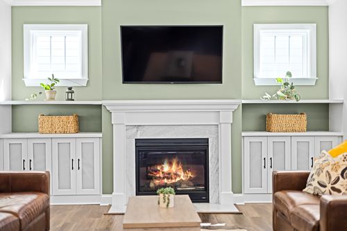 Free Cozy living room with a fireplace, TV, and stylish decor for a warm ambiance. Stock Photo
