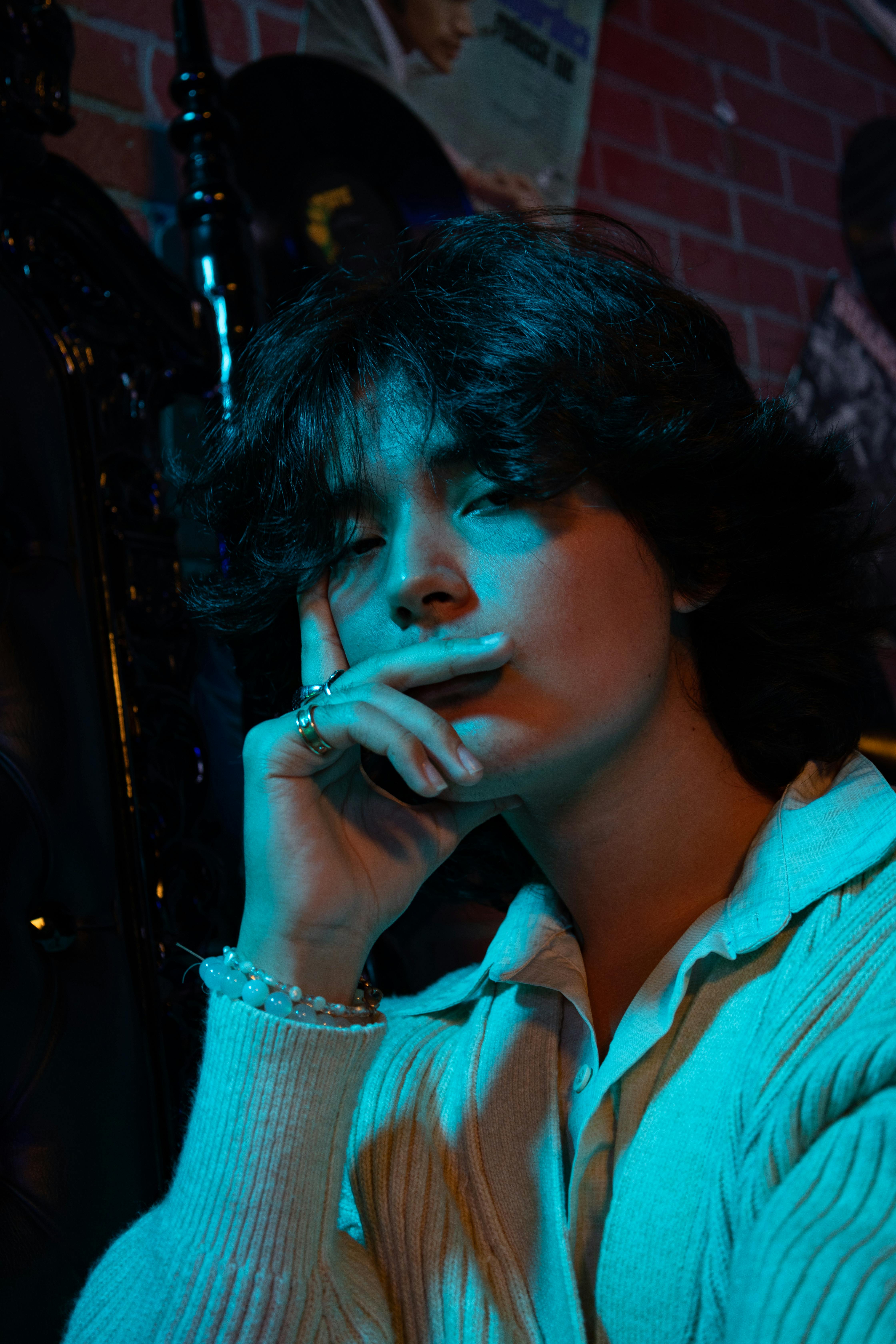 a woman smoking a cigarette in a dark room