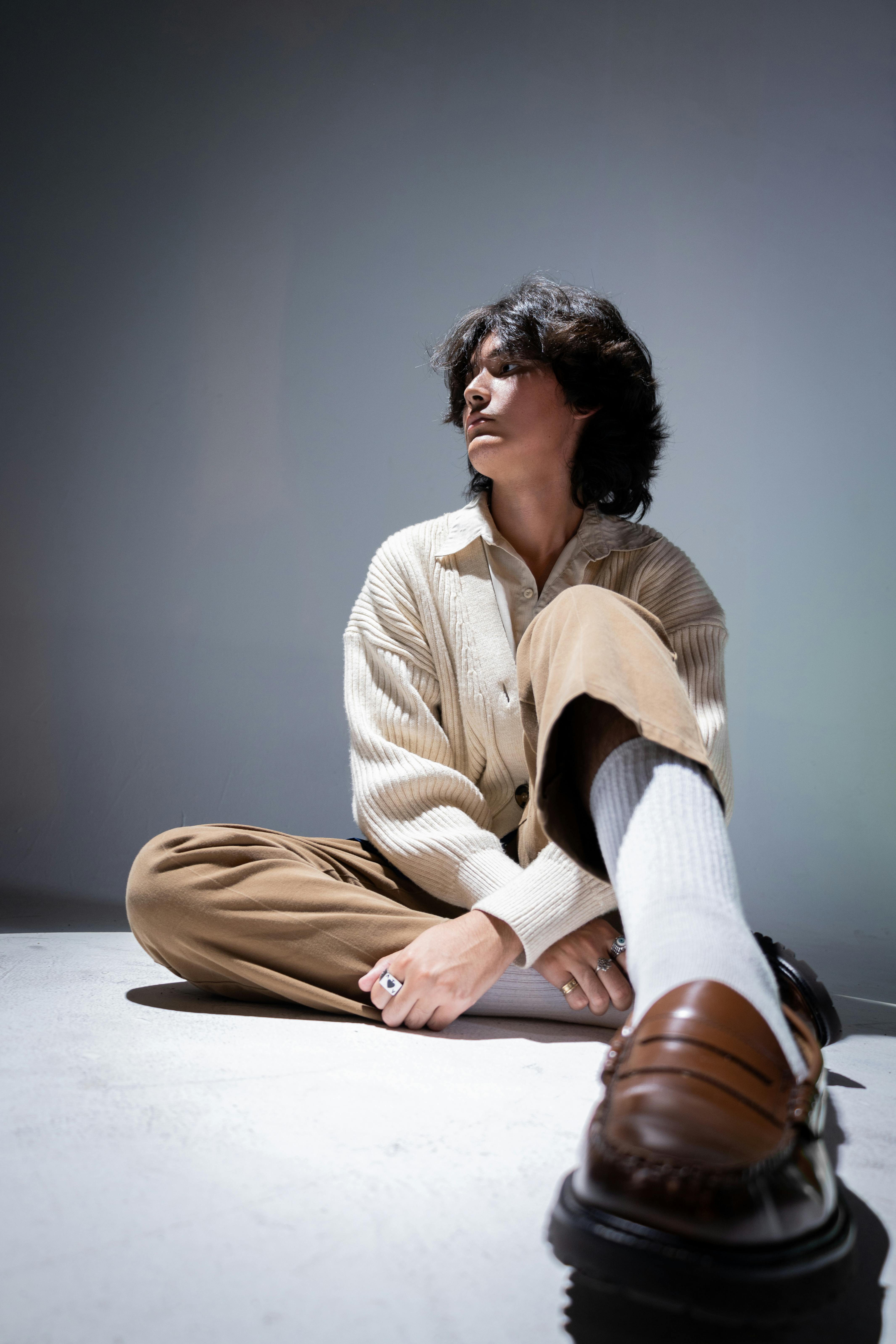 a woman sitting on the floor with her feet up