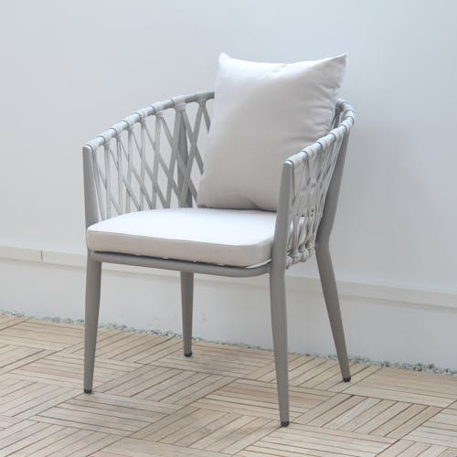 Gray Chair with Pillows on Wooden Floor
