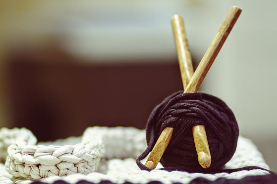 Brown Wooden Rod and Purple Yarn Ball Beside White Braided Cloth