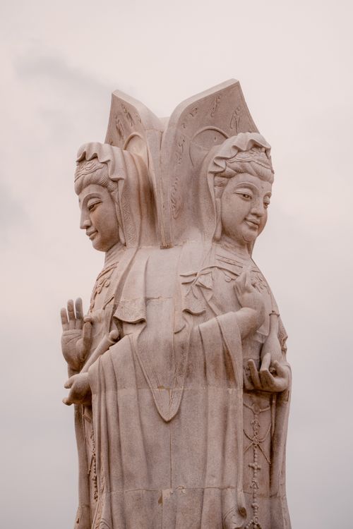 Free Vertical shot of dual Buddhist statues showcasing religious art and spirituality. Stock Photo