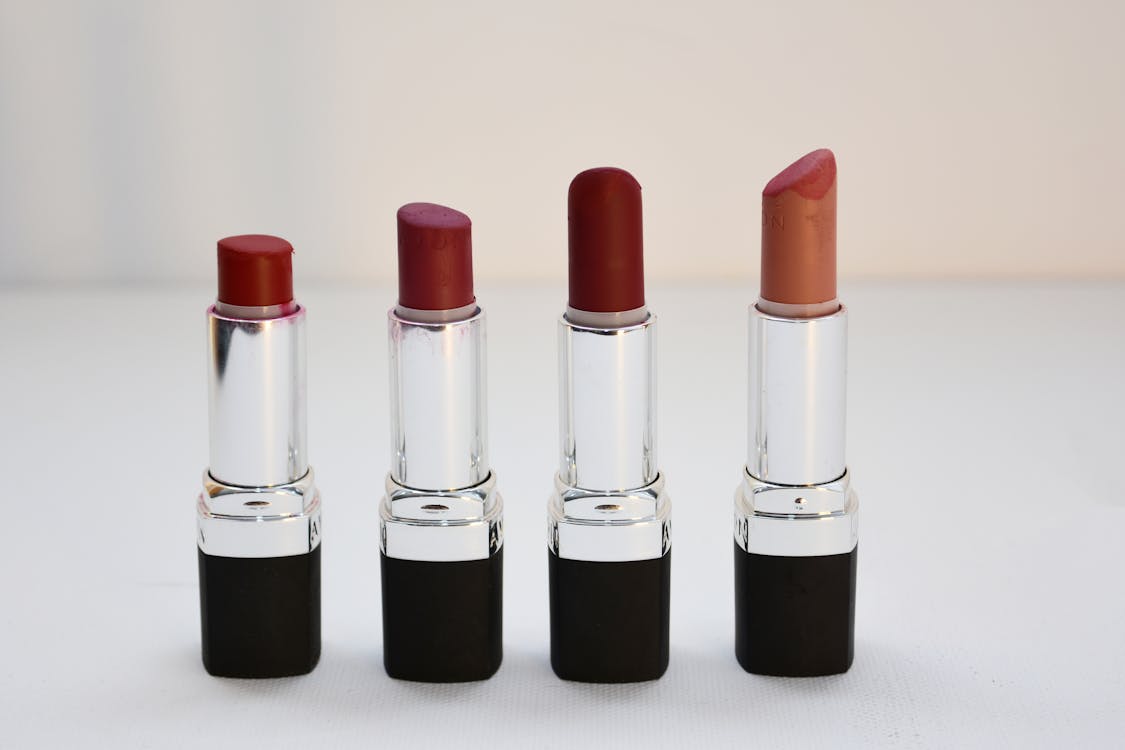 Free Four Aligned Assorted-color Lipsticks Stock Photo