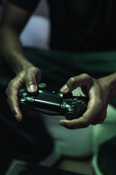 Focused gaming session with hands holding a controller, emphasizing the gaming experience.