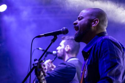 Singer performing at a microphone — photo by Anderson Guerra on Pexels