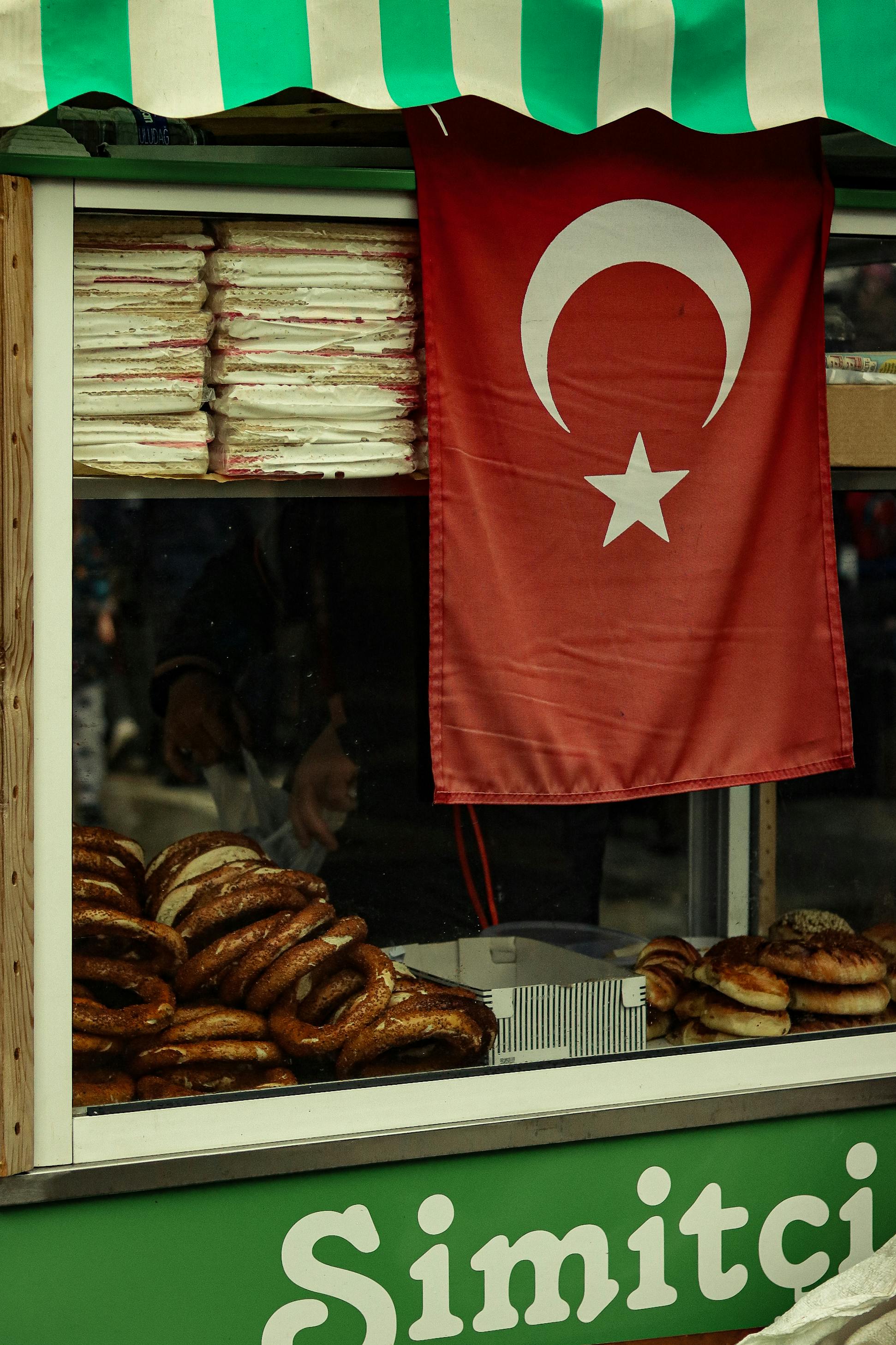 A stall selling simit bread in Turkey displays the national flag prominently.