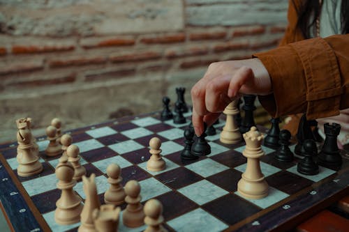 Close-up of Woman Moving a Chess Figure 