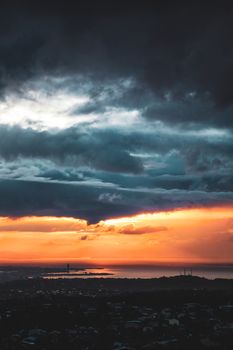 Vibrant sunset casting dramatic colors over the İzmir skyline and the Aegean Sea.
