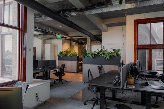 Contemporary office space with desks and plants in Amsterdam.
