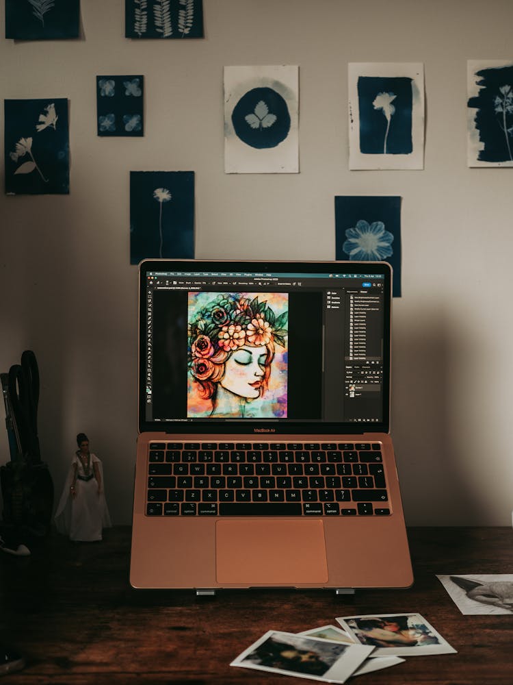 A Laptop Standing On A Desk Displaying An Illustration 