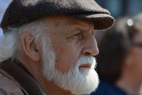 Selective Focus Photography of Man in Flat Cap during Daytime