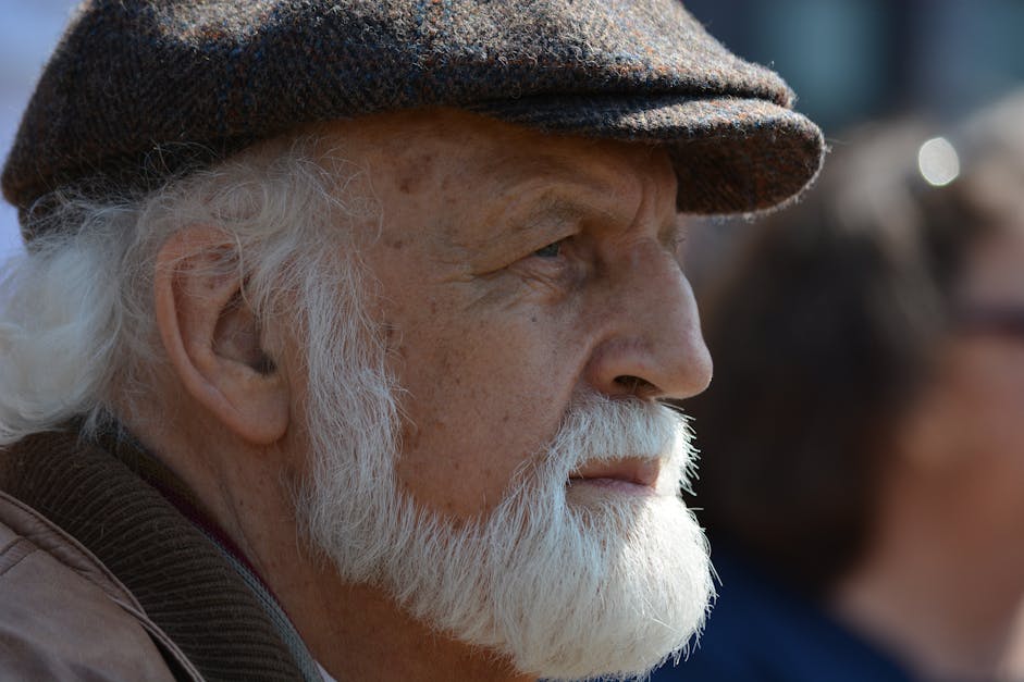 Selective focus photography of person wearing LA Dodgers cap