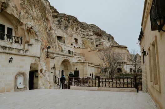 Explore the unique cave houses carved into rock formations in Cappadocia, Nevşehir, Türkiye.