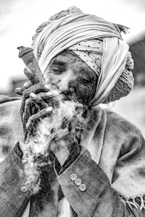 Free Black and White Photo of an Elderly Man in a Turban Smoking  Stock Photo