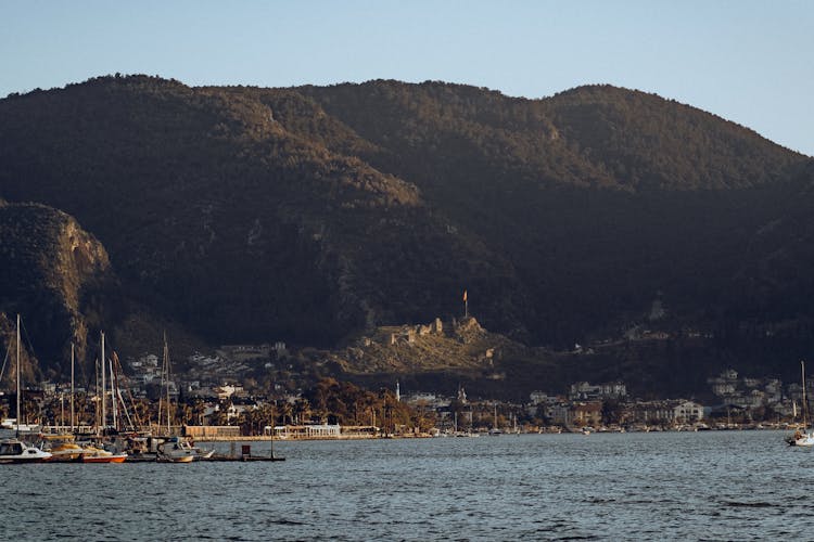 A Port With Boats Against A Mountain