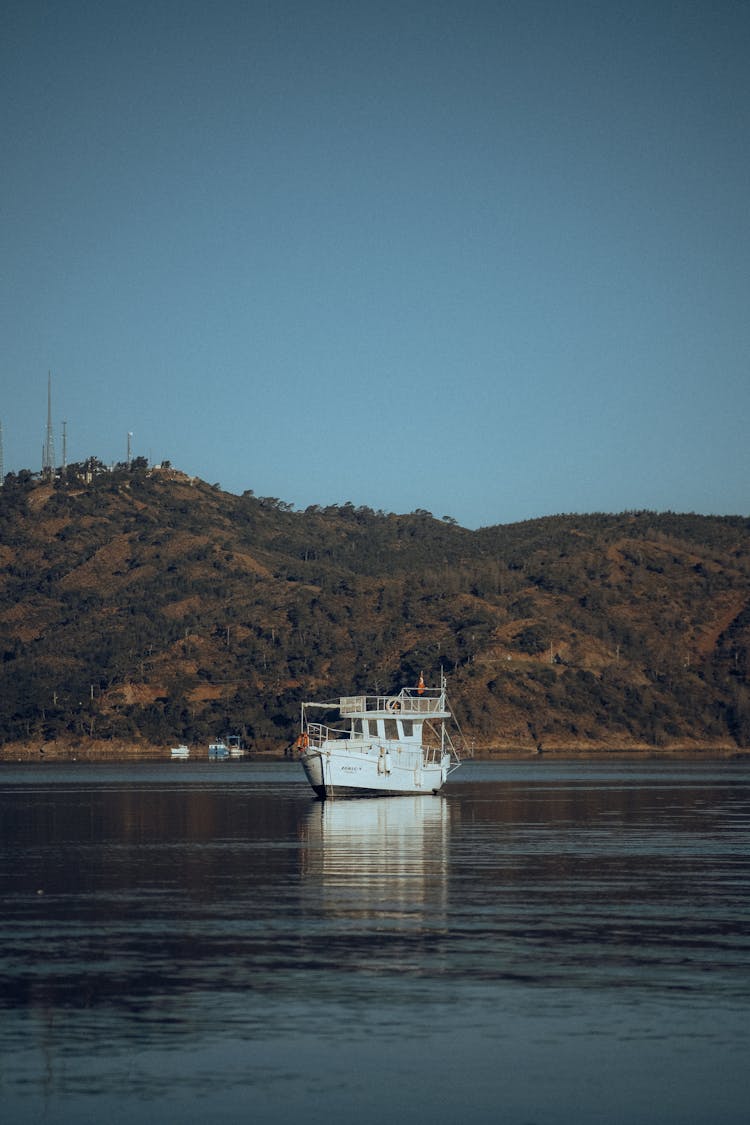 A Boat Floating On The Lake