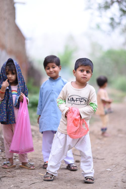 A Group of Little Children Standing Outdoors