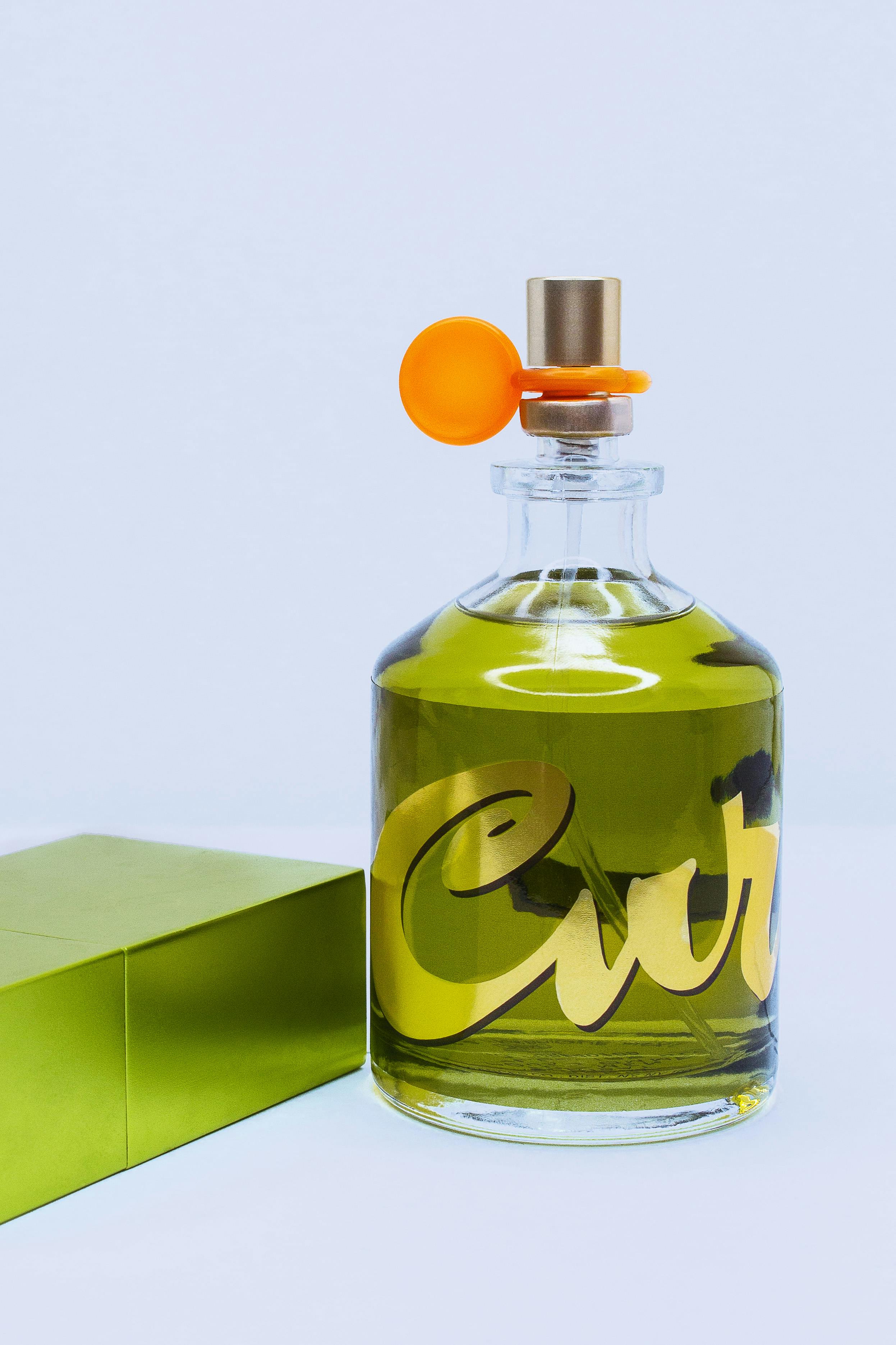 A Green Bottle of Perfume Free Stock Photo