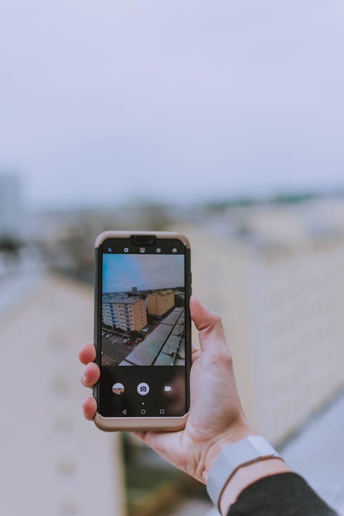 Free Person Taking Photo of Building \ Stock Photo