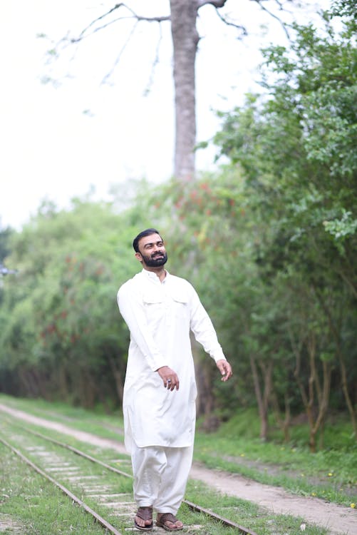 Man in Traditional Clothing Posing on Railway 