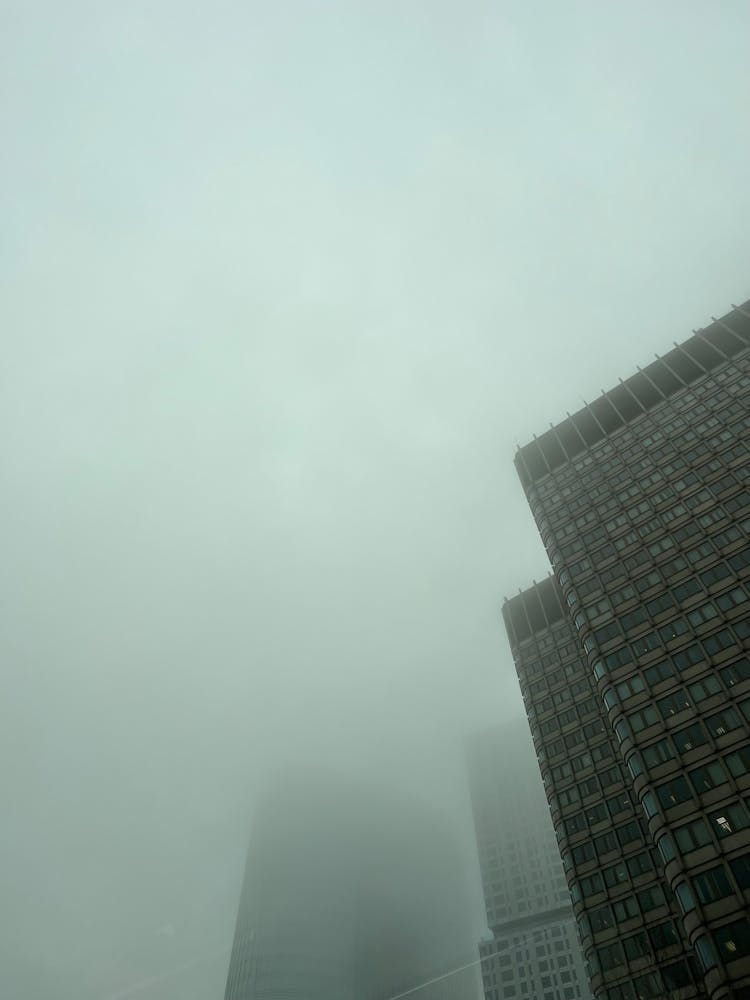 Low Angle View Of Skyscrapers Disappearing In Fog