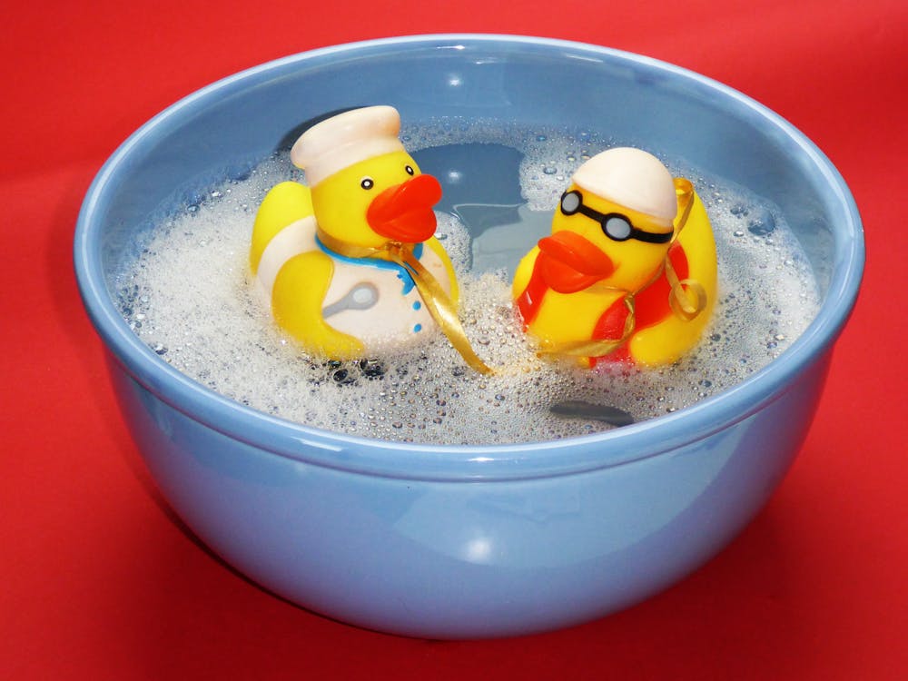 2 Rubber Ducky on Blue Ceramic Bowl