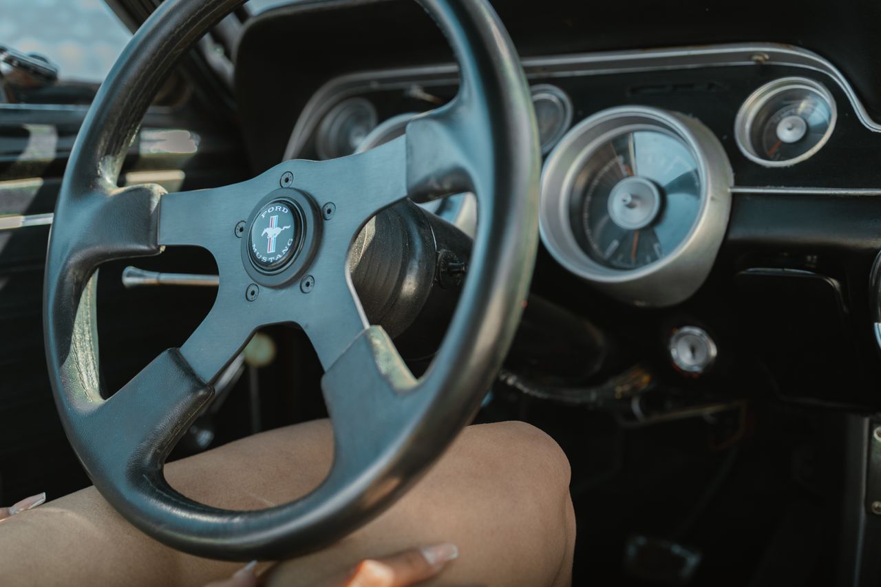 close up of a vintage ford mustang steering wheel and dashboard showca