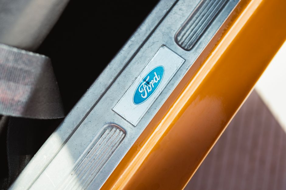 아이폰17 |모델·용량 선택 가이드 11 Detailed view of a Ford door sill on a classic orange car in Los Angeles, California.